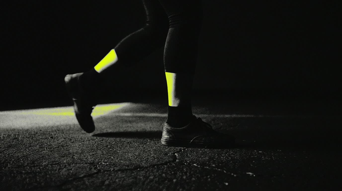 A leg lifted mid-step, lit from one side