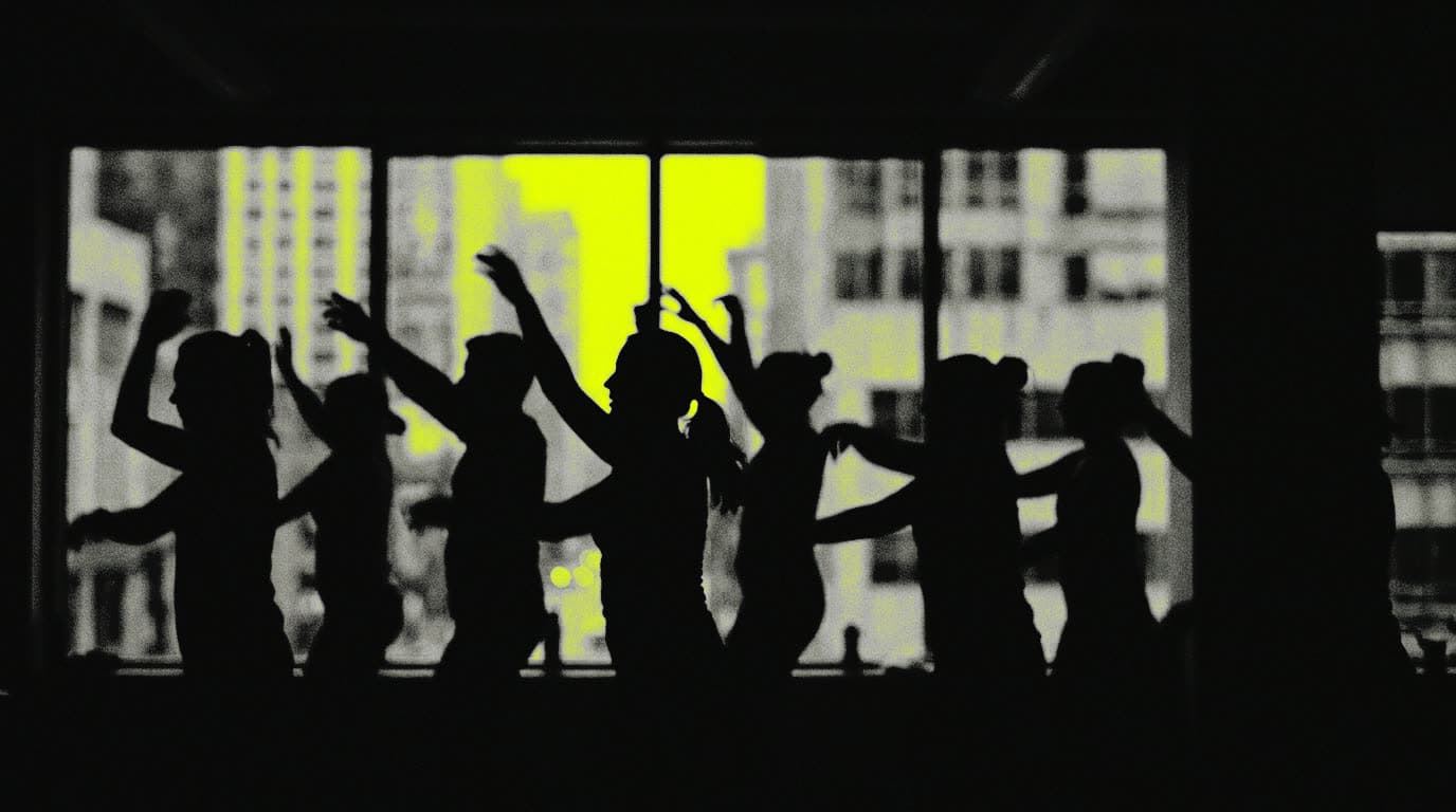 A STEPFIT class mid-count, arms raised, everyone in silhouette