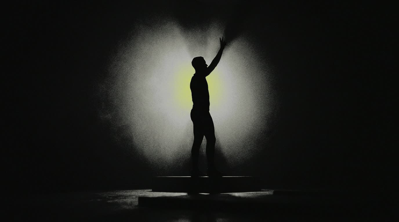 The view from the front of the room — a STEPFIT instructor in silhouette, one arm raised on the count