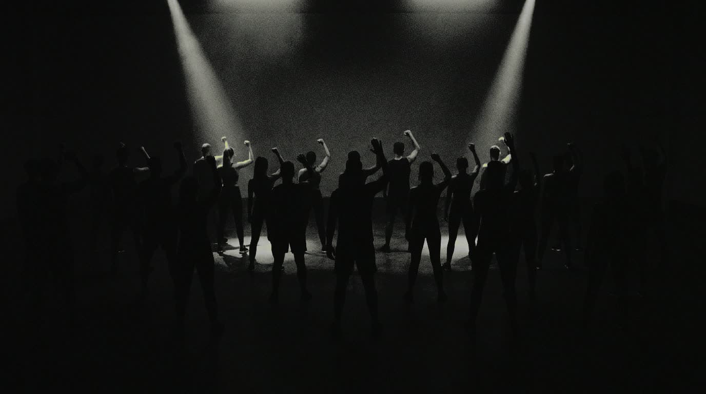 A full STEPFIT class seen from the back of the room, everyone in silhouette